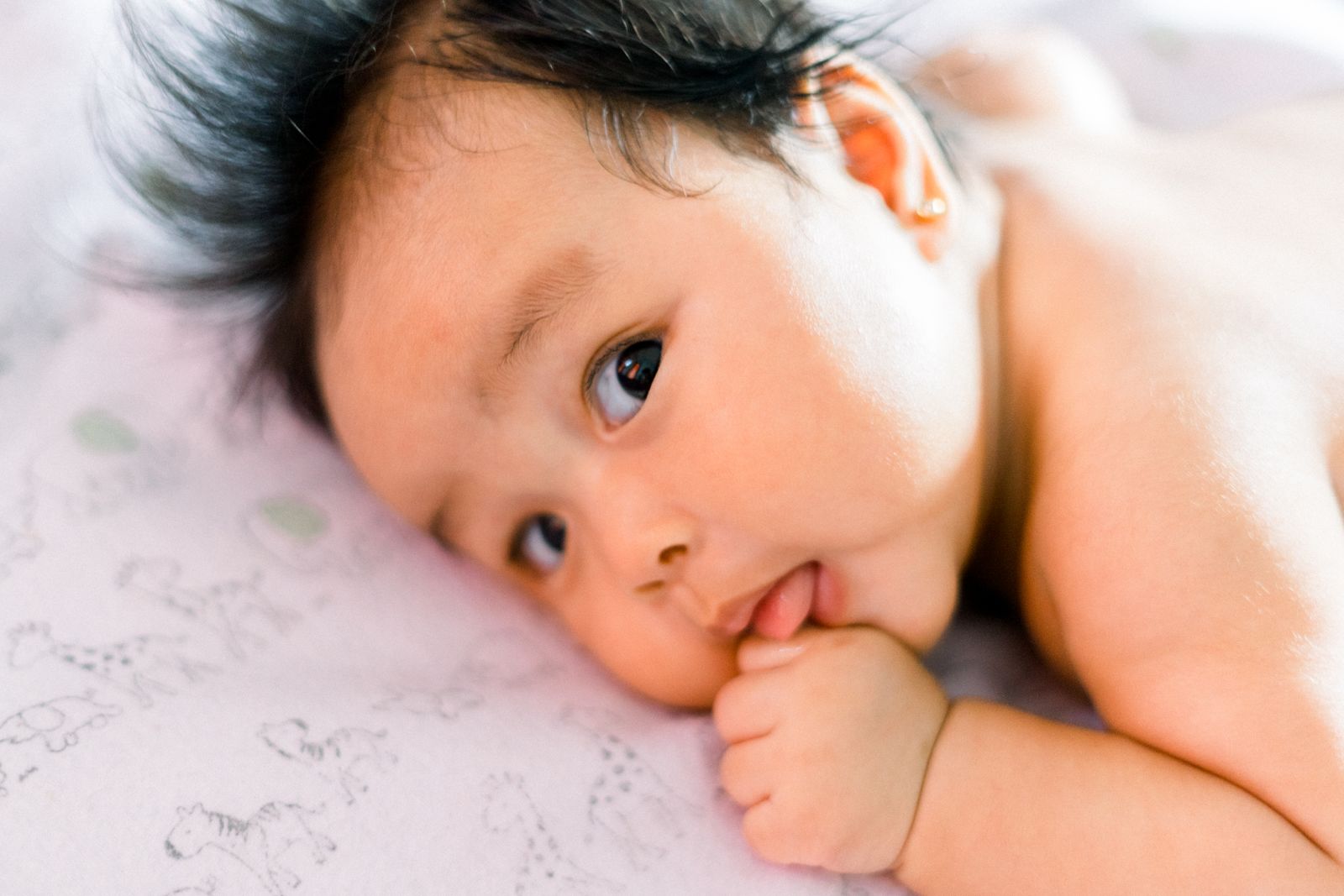 Close-up of a newborn's face and cheeks, where baby acne usually appears