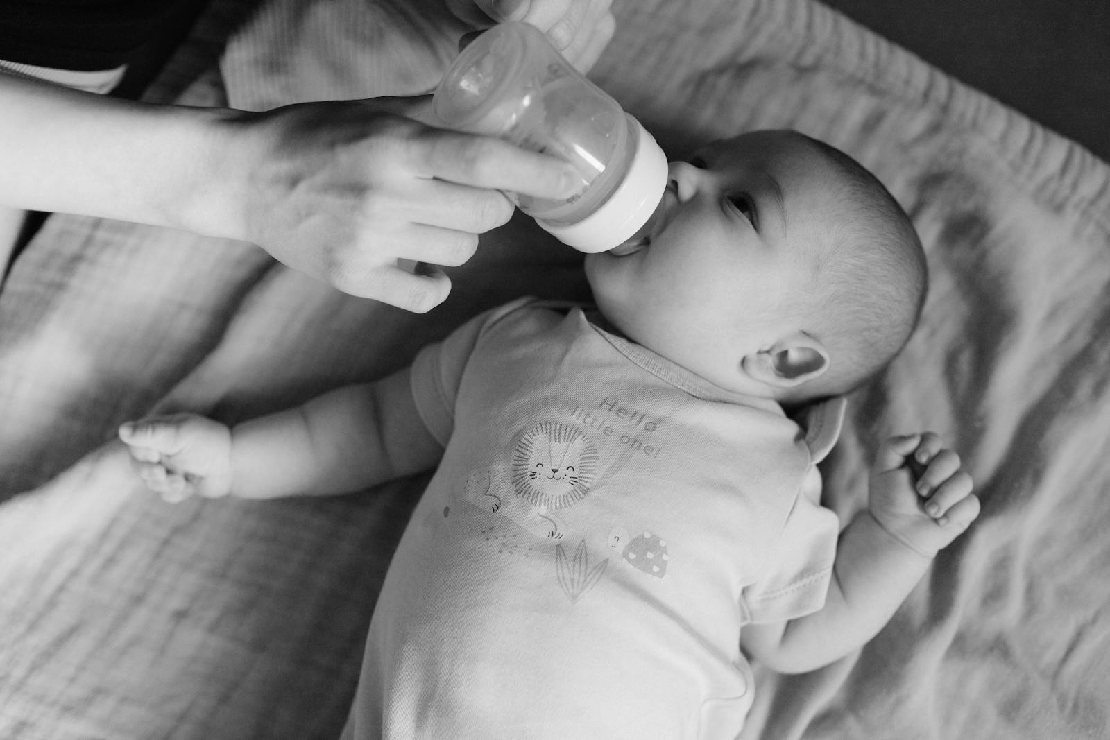 A baby drinking quietly from a bottle