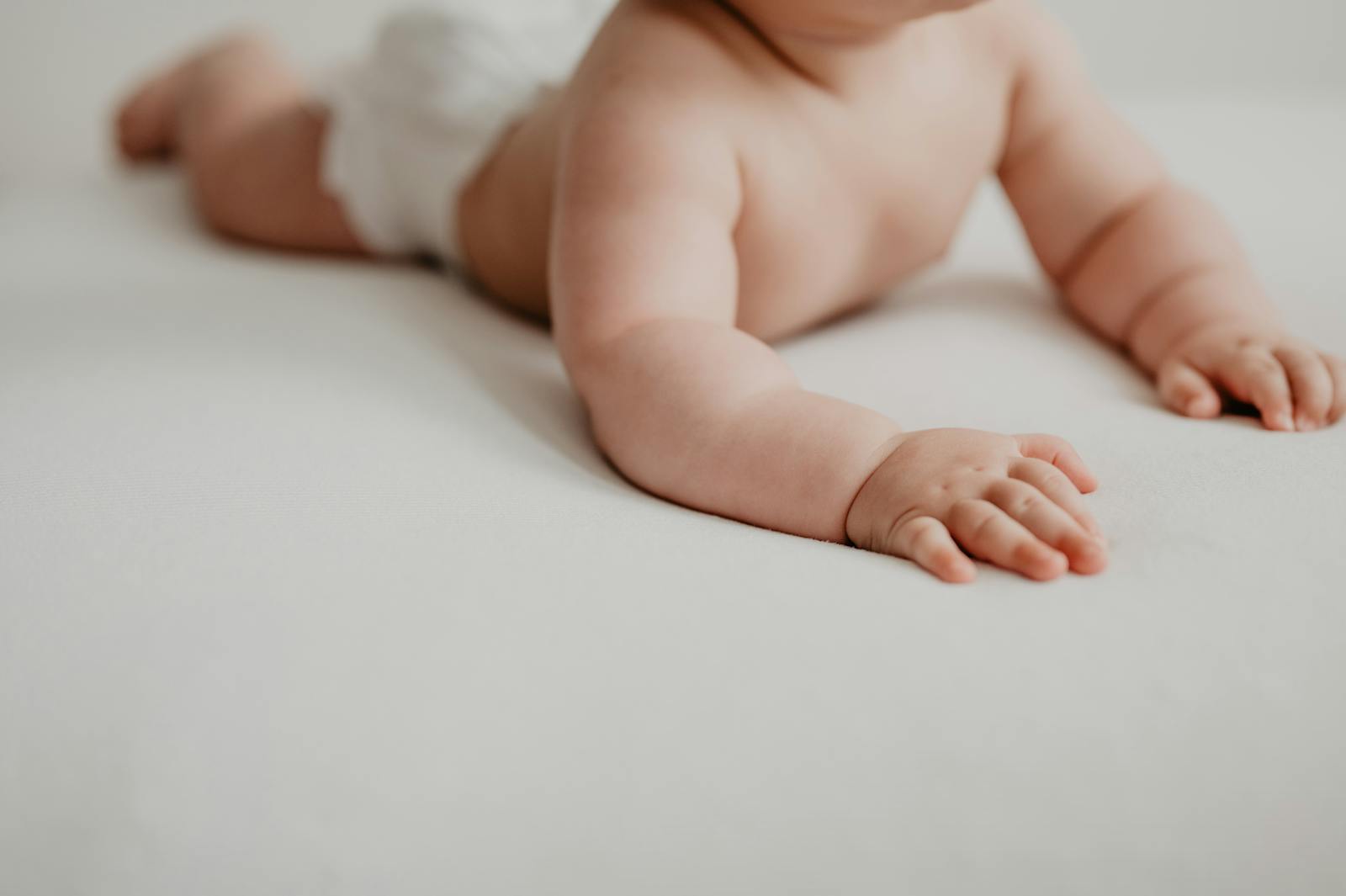 A baby's small hand resting in an adult palm