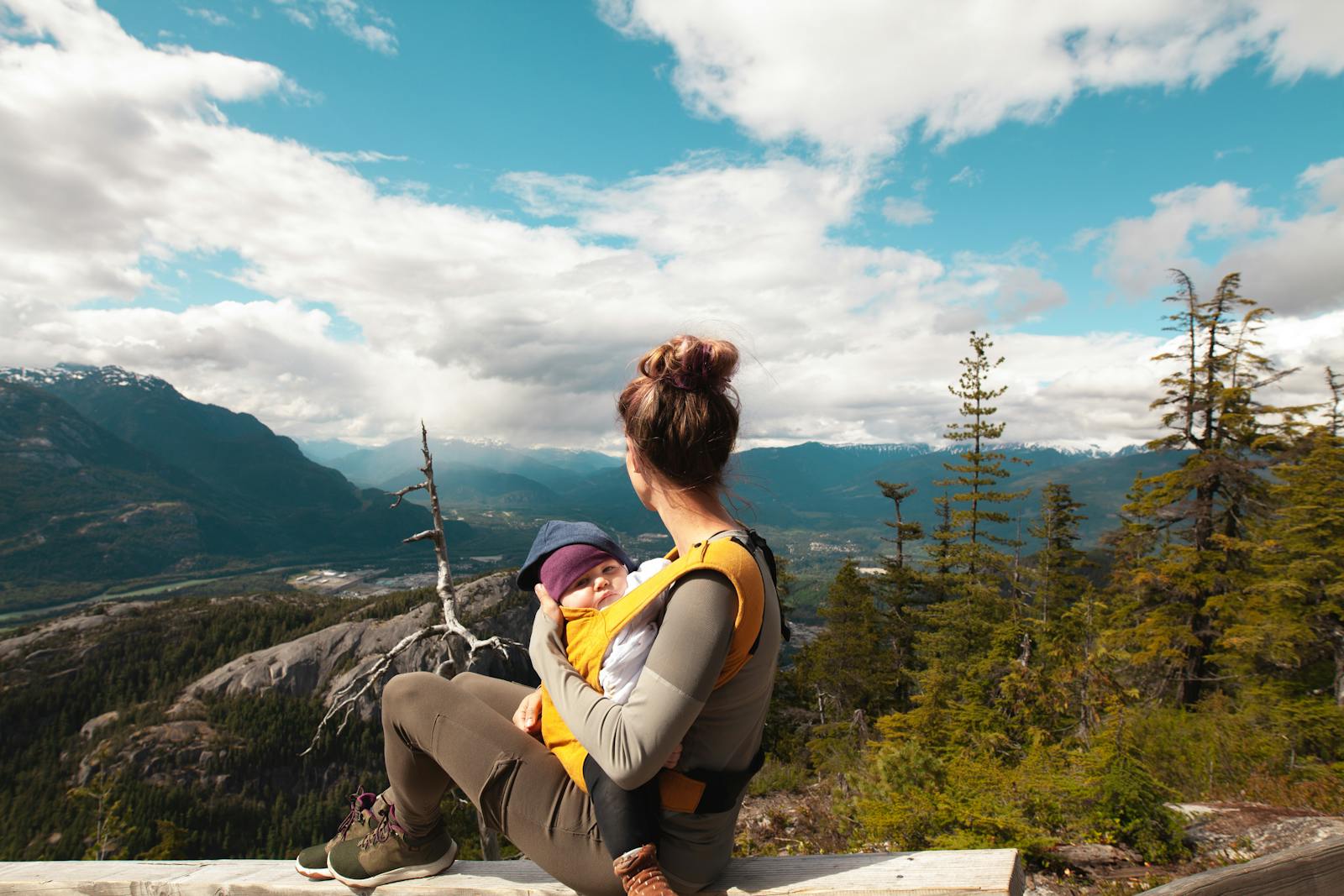 mom carrying baby outdoors