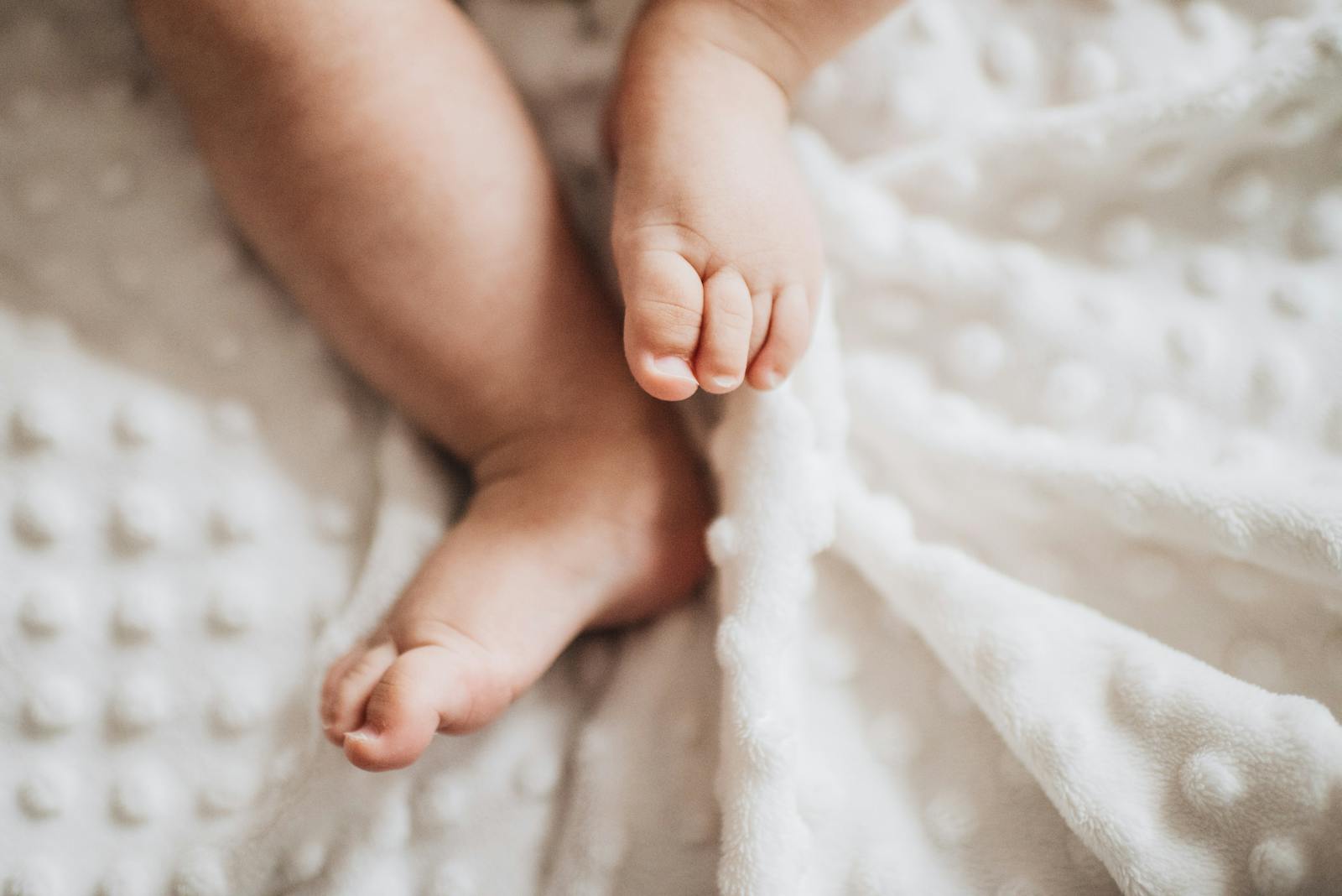 close-up of baby feet on soft blanket