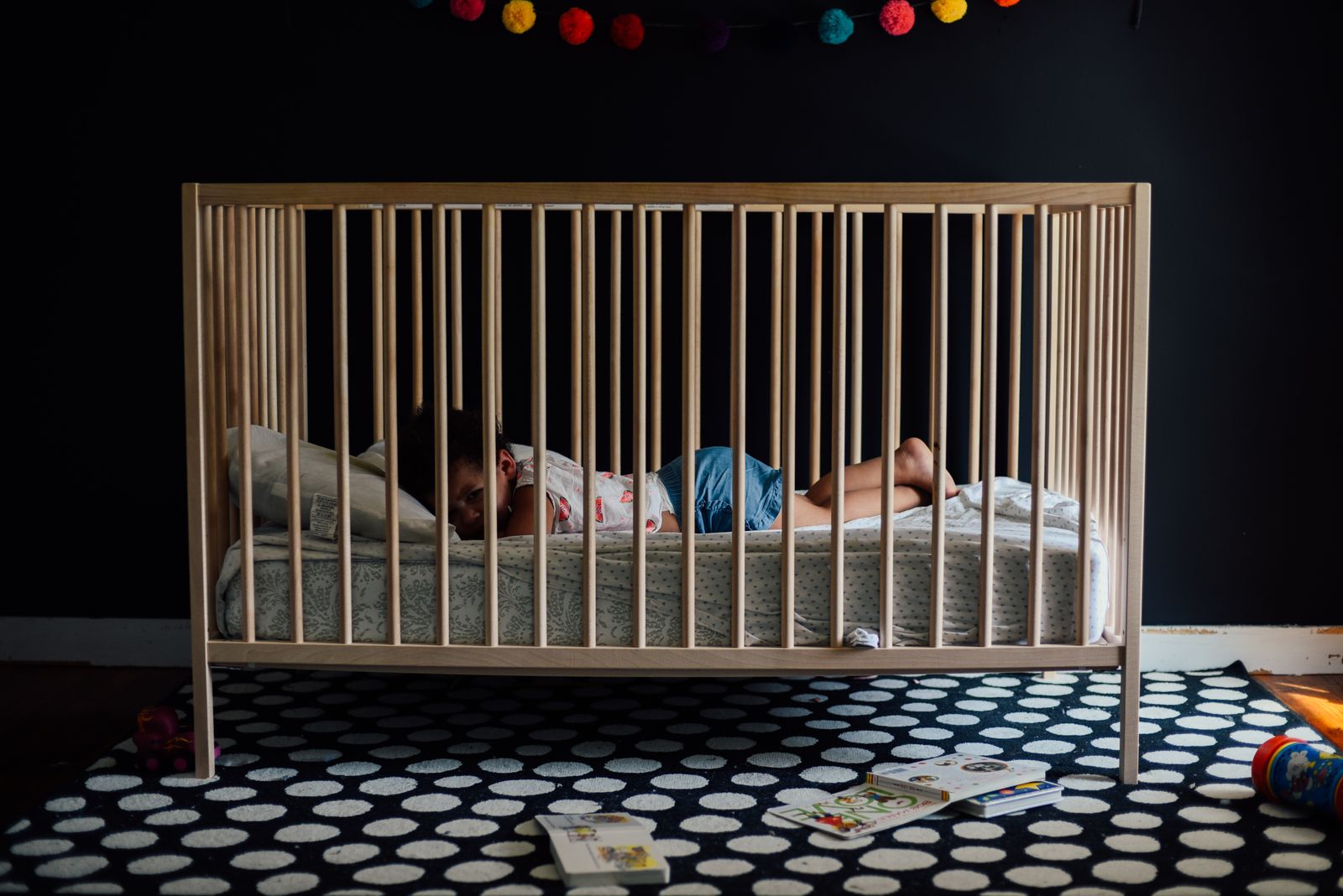 A baby sleeps peacefully in a crib in a cozy nursery